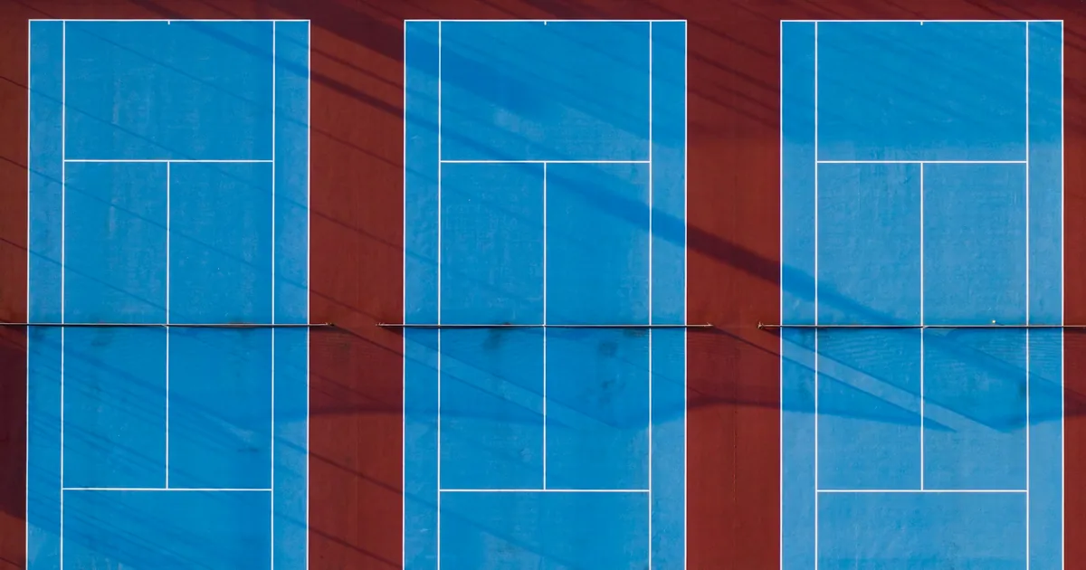 Aerial view of three blue tennis courts