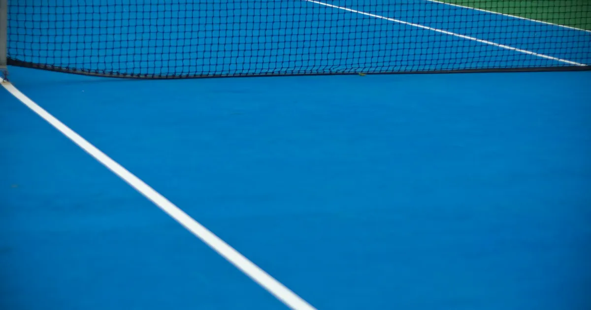 Filet et ligne blanche d'un court de tennis bleu